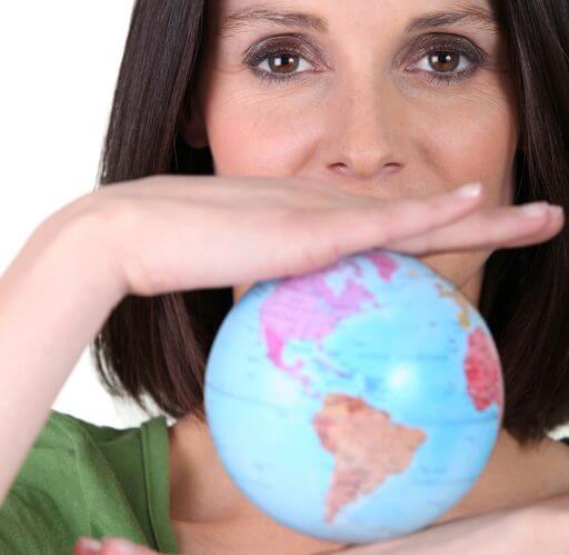 Woman holding a globe recommends Master Movers for international moves