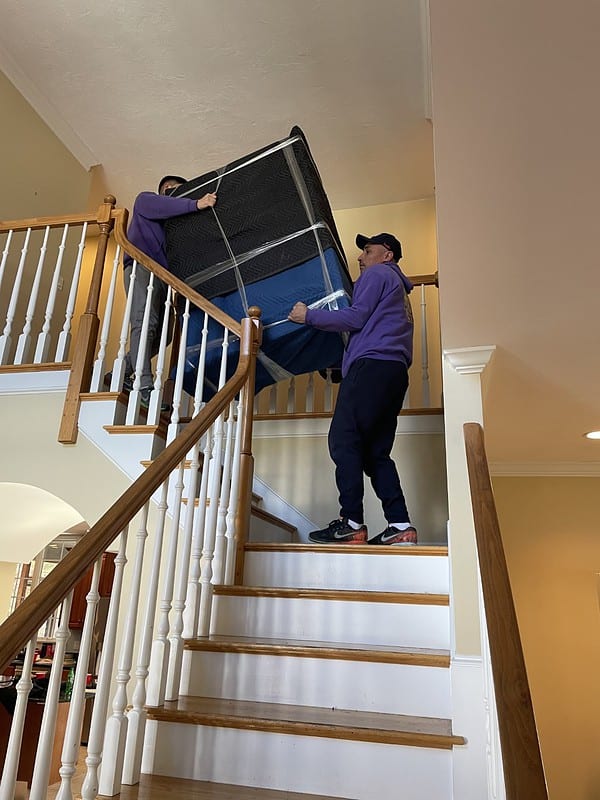 Movers Carrying Dresser